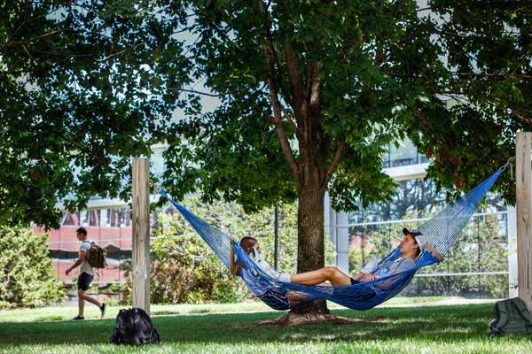 students laying on a hammock